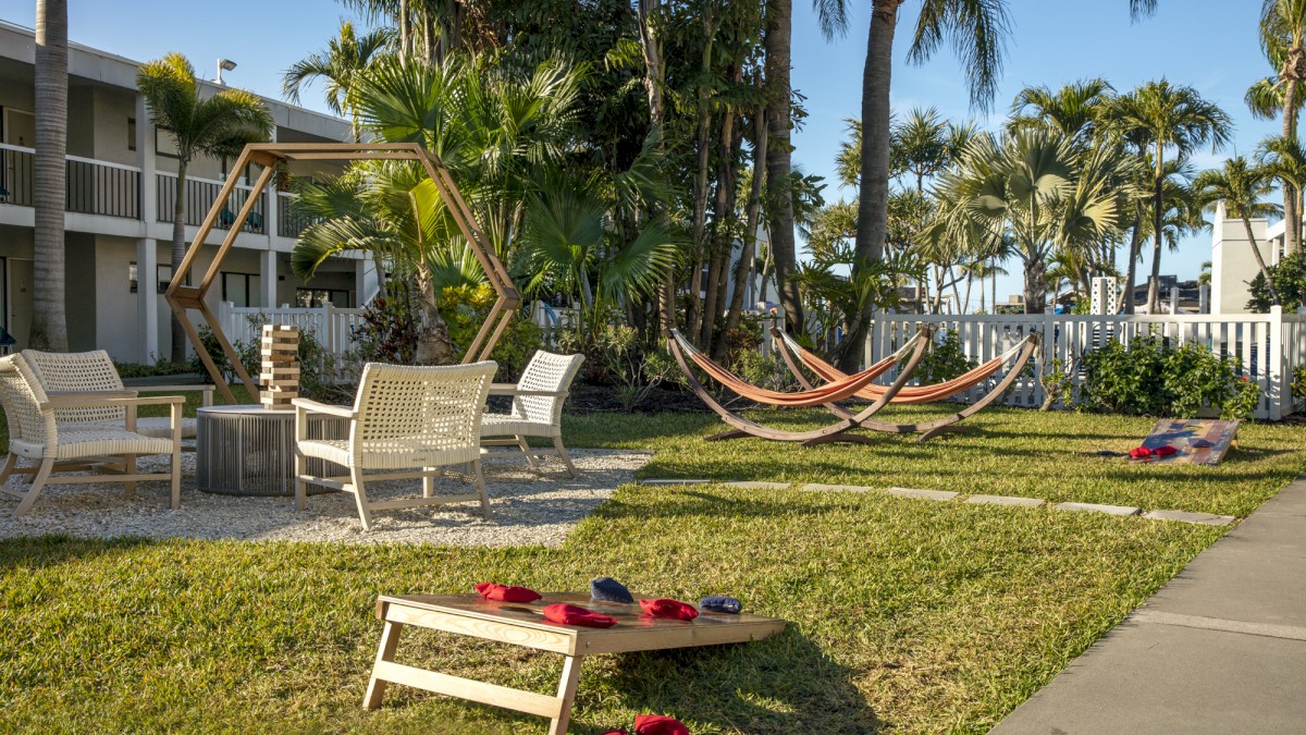 Relaxing backyard with hammock, chairs, and a giant Jenga game set.