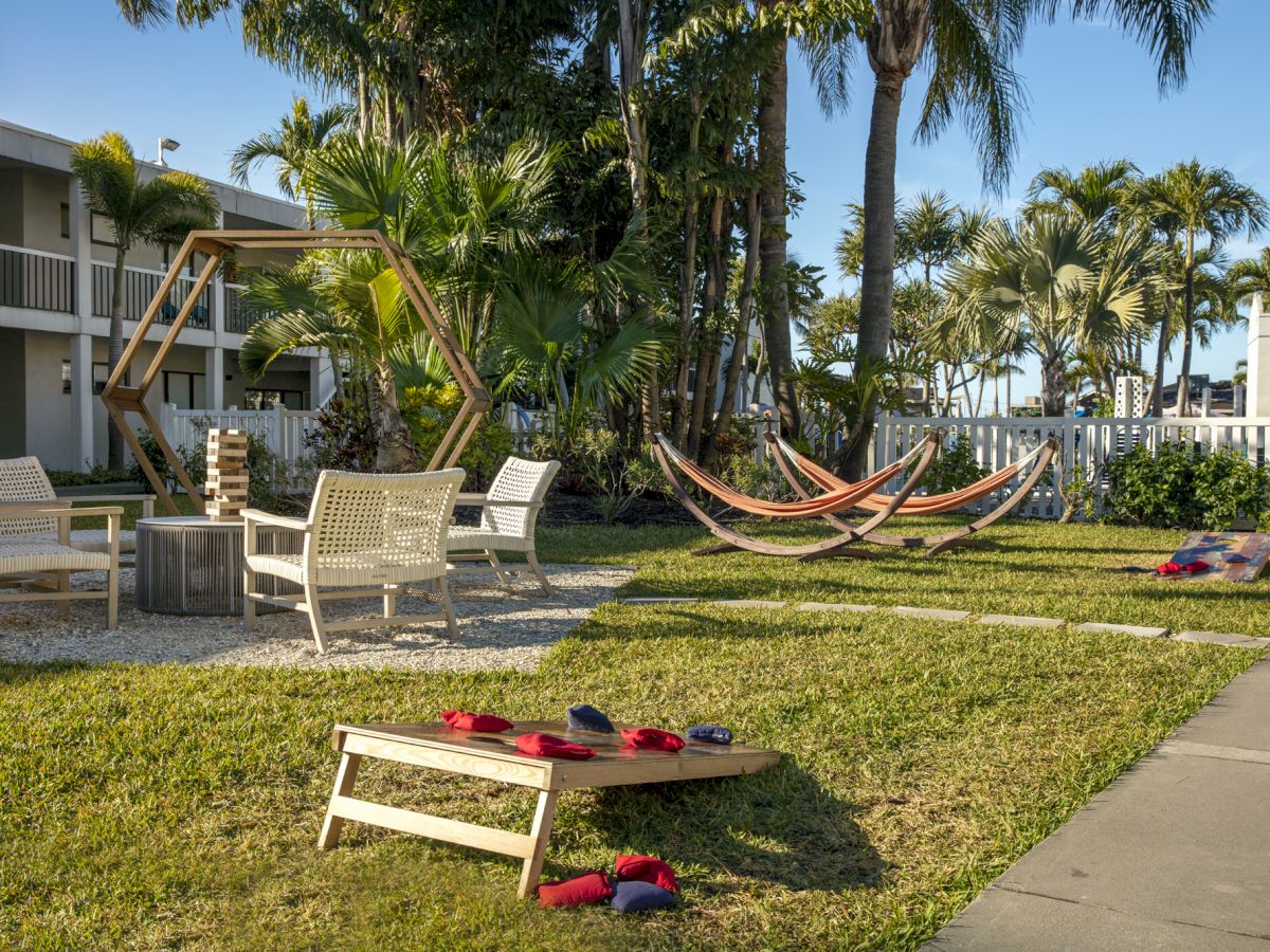 Relaxing backyard with hammock, chairs, and a giant Jenga game set.